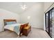 Well-lit bedroom featuring a vaulted ceiling, ceiling fan, and outdoor access at 2886 Green Meadow Ct, Clearwater, FL 33761