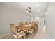 Dining room with a large wooden table, chandelier, and seating for eight at 2886 Green Meadow Ct, Clearwater, FL 33761