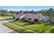 Well-maintained single-story home with a manicured lawn and mature landscaping at 2886 Green Meadow Ct, Clearwater, FL 33761