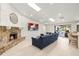 Bright and spacious living room features a stone fireplace, vaulted ceilings, and access to the lanai at 2886 Green Meadow Ct, Clearwater, FL 33761