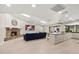 Open living space featuring a stone fireplace, modern lighting, and a breakfast bar at 2886 Green Meadow Ct, Clearwater, FL 33761