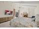 Large main bedroom with a stone fireplace, vaulted ceiling, and sliding door access to the pool at 2886 Green Meadow Ct, Clearwater, FL 33761