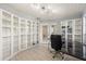 Bright office with wall-to-wall shelving and modern black glass desk at 2886 Green Meadow Ct, Clearwater, FL 33761