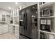 Pantry with stainless steel appliances, granite counters, and open built-in shelving at 2886 Green Meadow Ct, Clearwater, FL 33761
