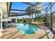 The screened pool with a waterfall, poolside lounging, and lush landscaping at 2886 Green Meadow Ct, Clearwater, FL 33761
