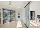 Light-filled sun room featuring a sliding barn door and views of the pool at 2886 Green Meadow Ct, Clearwater, FL 33761