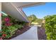 Pathway leads to a bright home entrance framed by lush, vibrant landscaping at 2886 Green Meadow Ct, Clearwater, FL 33761