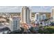 An aerial view shows the building in a city setting with red tiled roofs and palm trees at 300 Beach Ne Dr # 401, St Petersburg, FL 33701