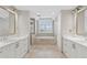Luxury bathroom with dual sinks, a soaking tub, and separate shower at 300 Beach Ne Dr # 401, St Petersburg, FL 33701