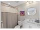 Clean bathroom features a tub, toilet, vanity, and a round mirror at 300 Beach Ne Dr # 401, St Petersburg, FL 33701