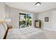 Bright bedroom with a slider door to a balcony, neutral paint and white bedding at 300 Beach Ne Dr # 401, St Petersburg, FL 33701