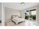 This bedroom boasts modern flooring and a sliding glass door leading to an outdoor balcony at 300 Beach Ne Dr # 401, St Petersburg, FL 33701