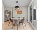 Elegant dining room featuring contemporary lighting, large windows, and seating for six at 300 Beach Ne Dr # 401, St Petersburg, FL 33701