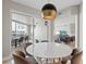 Bright dining area with modern lighting and sliding glass doors to the outdoor balcony at 300 Beach Ne Dr # 401, St Petersburg, FL 33701