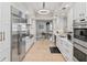 Bright, open kitchen with stainless steel appliances, white cabinets, and an adjacent dining area at 300 Beach Ne Dr # 401, St Petersburg, FL 33701