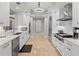 Modern kitchen with white cabinetry, stainless steel appliances, and granite countertops at 300 Beach Ne Dr # 401, St Petersburg, FL 33701