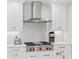 Modern kitchen features sleek white cabinetry, stainless steel appliances, and stylish tile backsplash at 300 Beach Ne Dr # 401, St Petersburg, FL 33701