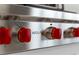 Close-up of a Wolf brand stove featuring professional-grade burners and red knobs at 300 Beach Ne Dr # 401, St Petersburg, FL 33701