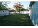 Fenced backyard showcasing green space and nearby residential buildings at 3421 E Powhatan Ave, Tampa, FL 33610