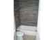 Updated bathroom featuring a tiled shower-tub and modern fixtures at 3421 E Powhatan Ave, Tampa, FL 33610