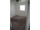 A carpeted bedroom is brightened by a window and lit by a ceiling fan at 3421 E Powhatan Ave, Tampa, FL 33610