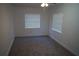Bright bedroom featuring two windows, neutral carpet, and recessed ceiling lights at 3421 E Powhatan Ave, Tampa, FL 33610