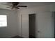 A carpeted bedroom is brightened by a window and lit by a ceiling fan at 3421 E Powhatan Ave, Tampa, FL 33610