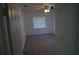 A bright bedroom with neutral carpet, a ceiling fan, and natural light from a window at 3421 E Powhatan Ave, Tampa, FL 33610