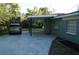 View of the carport with ample space for parking and easy access to the entrance at 3421 E Powhatan Ave, Tampa, FL 33610