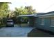 A car sits parked in the covered carport of this well maintained home at 3421 E Powhatan Ave, Tampa, FL 33610