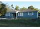 Quaint home featuring fenced yard and well-lit windows at 3421 E Powhatan Ave, Tampa, FL 33610