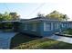 Charming home with a well-kept exterior, carport and tidy landscaping at 3421 E Powhatan Ave, Tampa, FL 33610