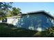 Exterior view of the home showcasing its simple architecture and well-maintained yard at 3421 E Powhatan Ave, Tampa, FL 33610
