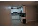 Modern kitchen featuring white cabinets, granite counters, and stainless steel appliances at 3421 E Powhatan Ave, Tampa, FL 33610