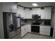Modern kitchen with stainless steel appliances, granite countertops and ample cabinet space at 3421 E Powhatan Ave, Tampa, FL 33610