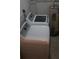 This laundry room has a washer, dryer, and water heater at 3421 E Powhatan Ave, Tampa, FL 33610