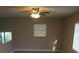 Open-plan living room features neutral paint, and ceiling fan with lights at 3421 E Powhatan Ave, Tampa, FL 33610