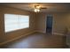 Open-plan living room features neutral paint, tile floor, and a window at 3421 E Powhatan Ave, Tampa, FL 33610