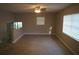 Open-plan living room features neutral paint, tile floor, large window, and ceiling fan with lights at 3421 E Powhatan Ave, Tampa, FL 33610