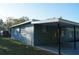 Rear exterior of home featuring a covered carport area at 3421 E Powhatan Ave, Tampa, FL 33610