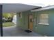 Rear exterior of home with access to covered carport at 3421 E Powhatan Ave, Tampa, FL 33610