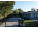 Rear exterior view showing covered parking and backyard at 3421 E Powhatan Ave, Tampa, FL 33610