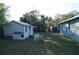 Backyard shed and playset, complemented by green lawn and foliage at 3421 E Powhatan Ave, Tampa, FL 33610