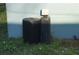 View of a utility tank and a water softener system outside the home at 3421 E Powhatan Ave, Tampa, FL 33610