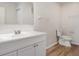Bathroom with white vanity, large mirror, and updated fixtures at 406 S Pebble Beach Blvd, Sun City Center, FL 33573