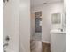 Bathroom with white tile and vanity, featuring bright lighting and modern fixtures at 406 S Pebble Beach Blvd, Sun City Center, FL 33573