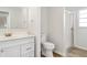Bathroom with white vanity, updated fixtures, and walk-in shower with glass doors at 406 S Pebble Beach Blvd, Sun City Center, FL 33573