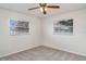 Bedroom with neutral carpet, and two windows offering natural light at 406 S Pebble Beach Blvd, Sun City Center, FL 33573