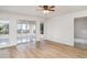 Bright, airy bedroom features light wood floors and sliding glass doors to sunroom at 406 S Pebble Beach Blvd, Sun City Center, FL 33573