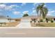 Charming single-story home featuring a well-manicured lawn and a spacious two-car garage at 406 S Pebble Beach Blvd, Sun City Center, FL 33573